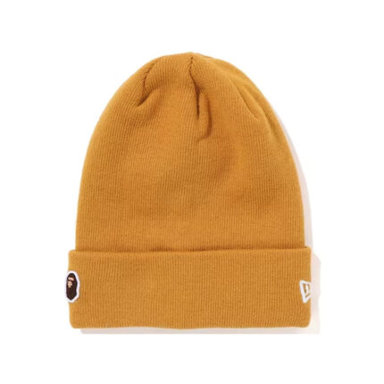 BAPE Ape Head One Point New Era Knit Beanie - Orange, adding a vibrant touch to your streetwear ensemble.